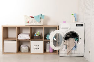 Washing machine with dirty towels in laundry room