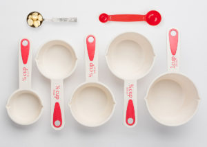 Set of Measuring Cups Staggered on White Background Top View
