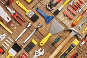 Carpentry tools arranged diagonally on wood - Knolling